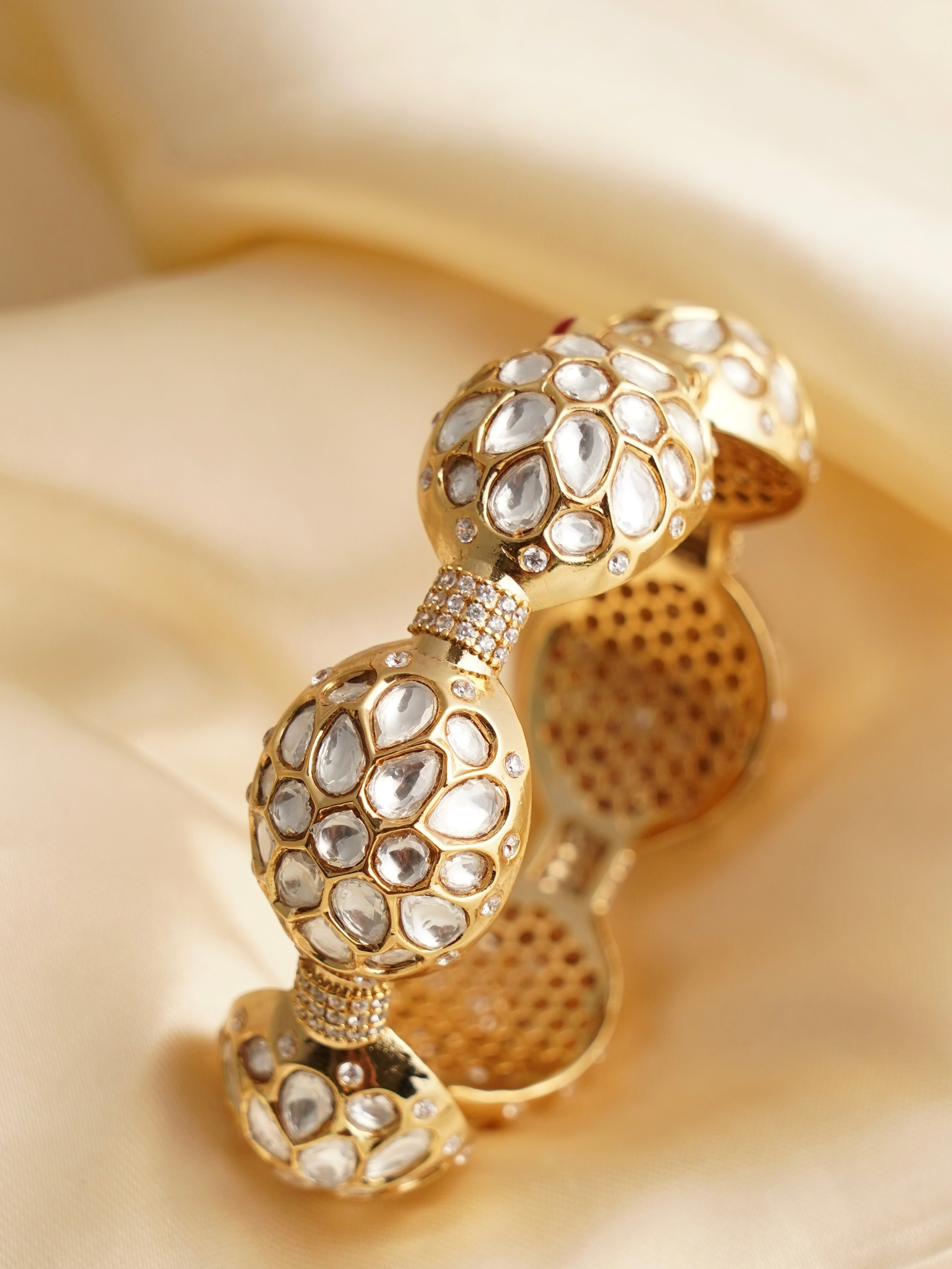 Overhead view of gold-finished kundan polki kada showcasing stone arrangement